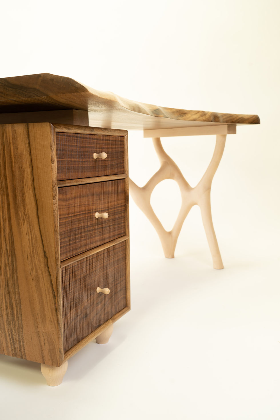 Side view of bespoke walnut office desk with drawers, handmade custom wood furniture for home office.