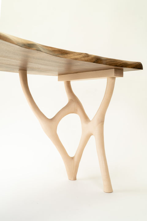 This is a bespoke solid walnut office desk with drawers on one side and an organic design for the legs. It is made from english walnut.