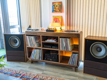 A bespoke record player cabinet in solid walnut with a pair of Tannoy Arden speakers
