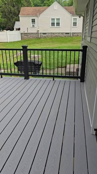 Close-up view of gray composite decking with metal railing