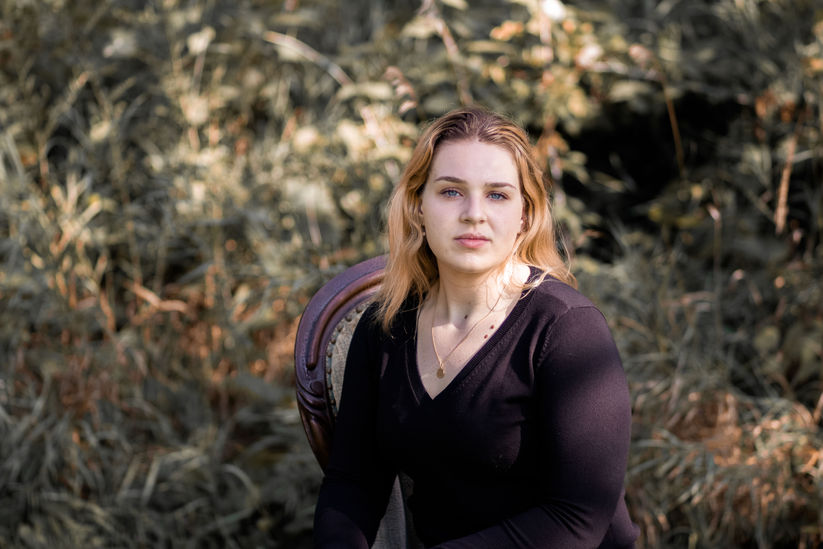Senior portrait with sunset light in Central New York field