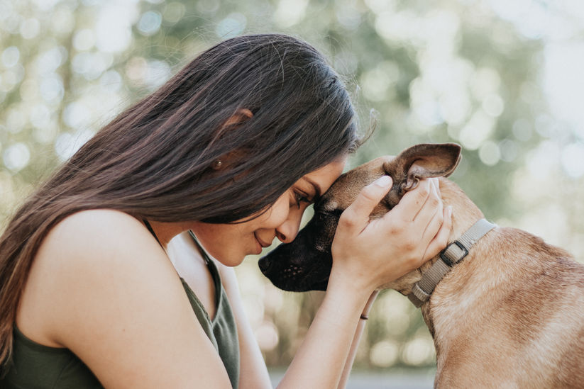Woman playing with dog in Central New York backyard