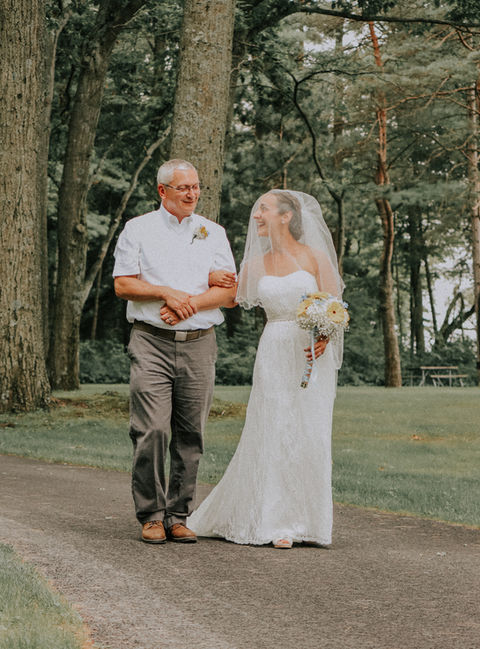 Wedding couple walking through fall leaves in Central New York.