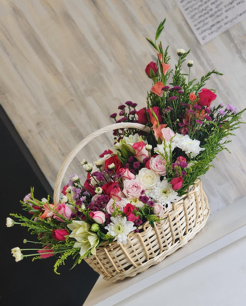 Experience elegance with Delightful flower basket, featuring a stunning mix of roses elegantly arranged in a beautiful basket