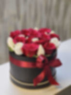 Emma Flower Box delivers a powerful message of love with a sleek black hat box filled with stunning red roses.