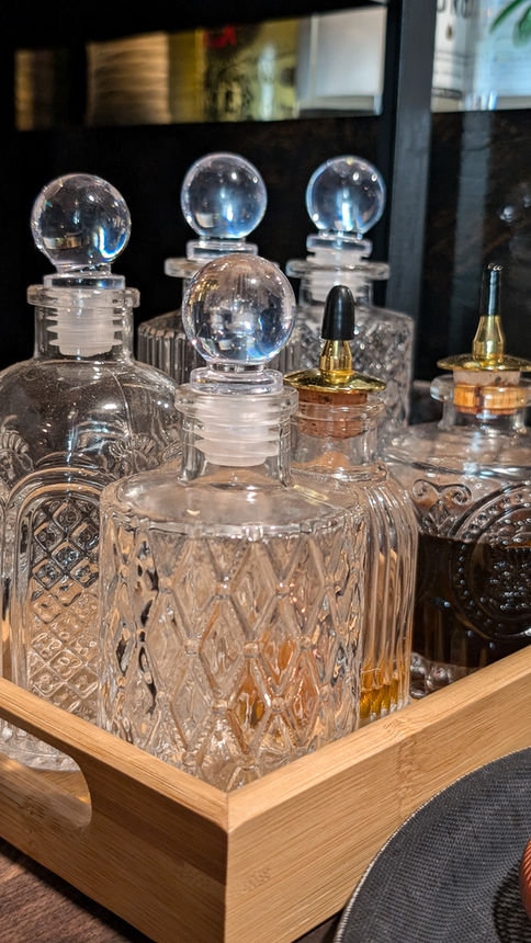 the wych bar ware closeup bitters bottles glass ware beautiful containers and bamboo tray for cocktails