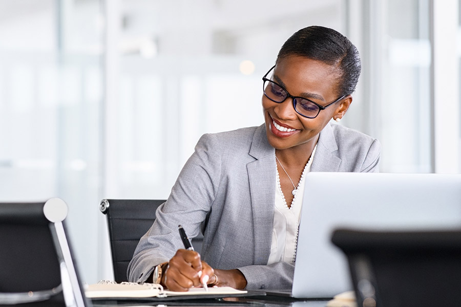 Professional woman reviewing notes while validating a digital product idea