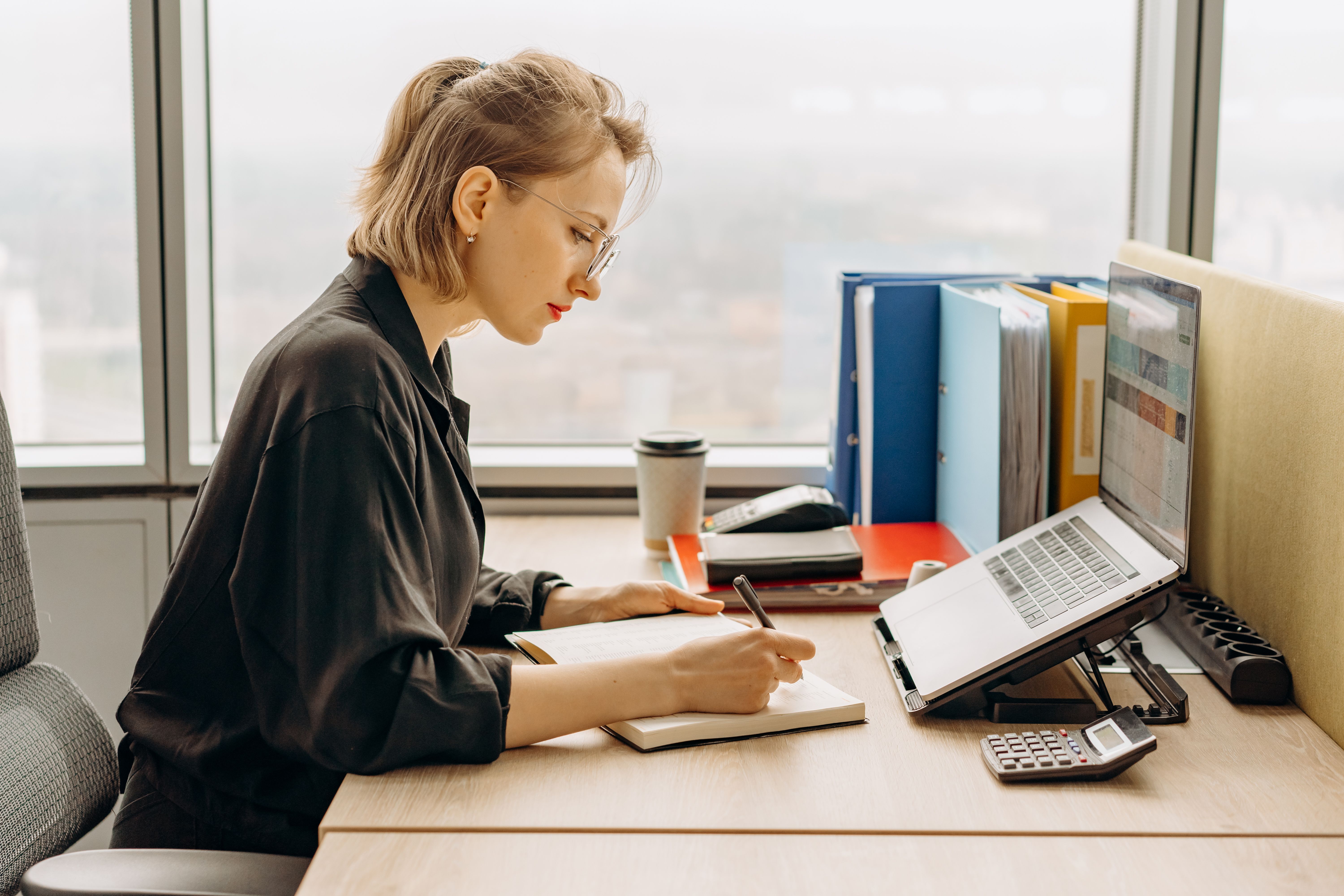 Professional woman creating a digital product outline at her office desk