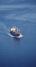 Cargo ship sailing on calm blue ocean waters