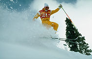 Olympic skier in action, soaring through snowy slopes