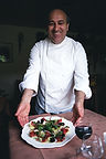 Smiling chef presenting delicious salad, birchhillchambers