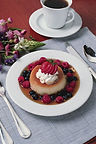 Flan with berries and whipped cream, coffee