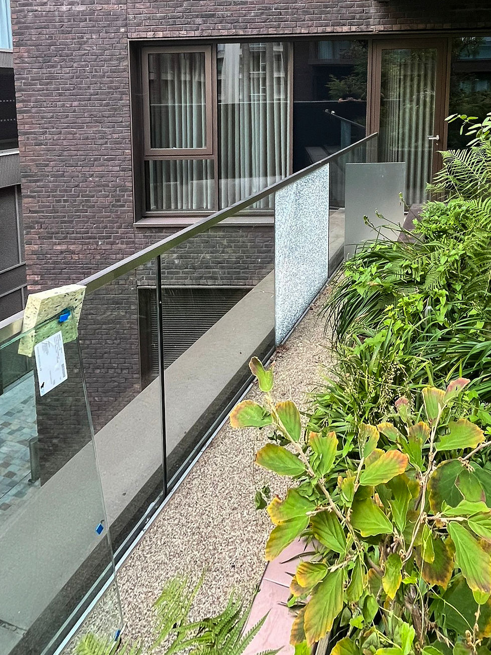 balustrade glazed panel shattered - safety glass so it fragments - still in place on a balcony in London high rise luxury apartment. 