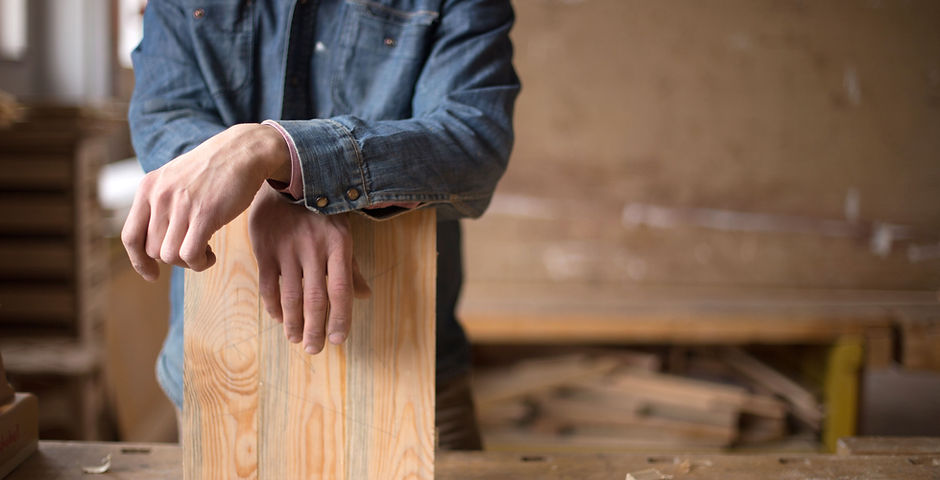 Carpenter Leaning on Piece of Wood