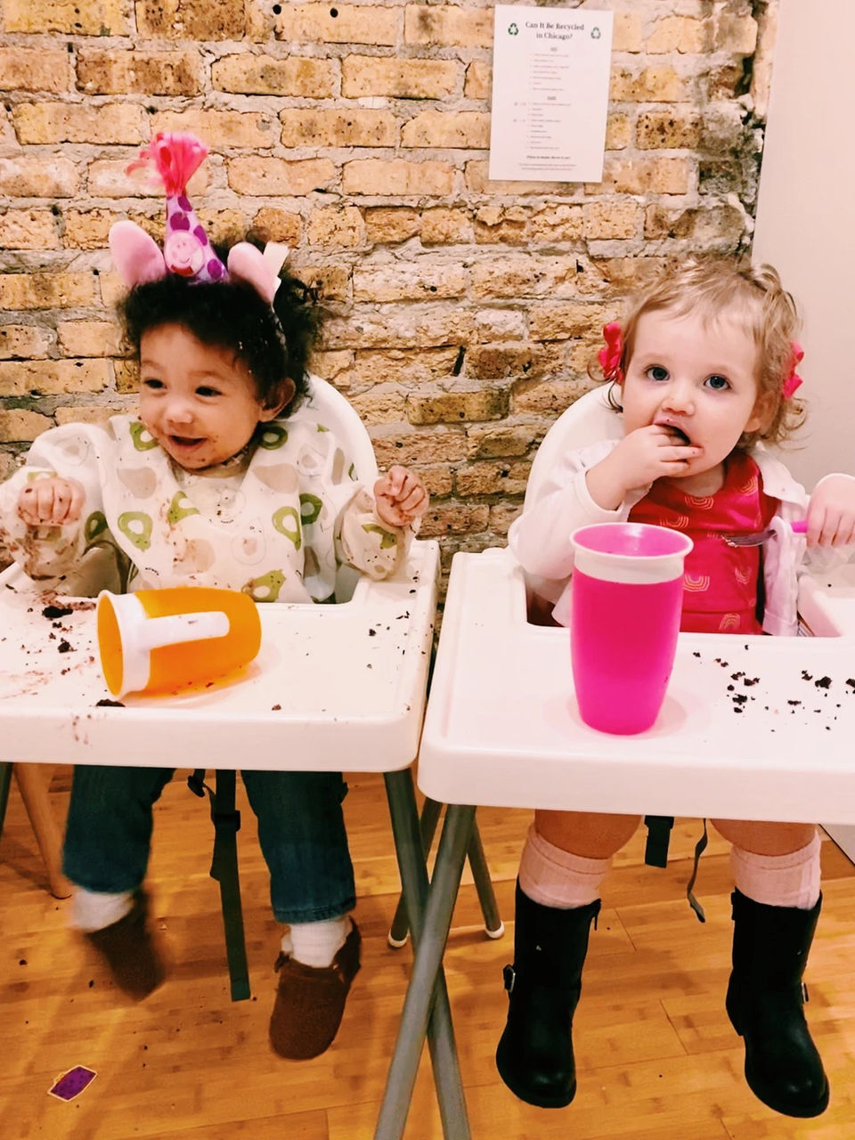 Two small children sitting on high chairs