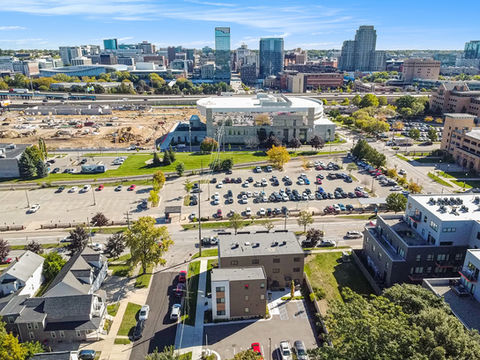 Aerial view of a city with buildings and parking lots