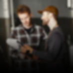 Two mechanics reviewing paperwork at First Watch Service Center