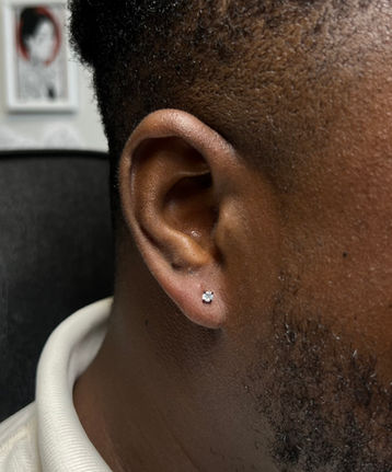 Man's ear with small piercing