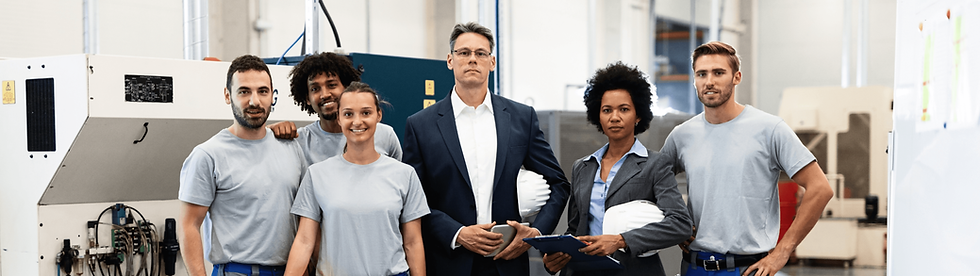 portrait-group-engineers-corporate-managers-standing-factory-looking-camera.png