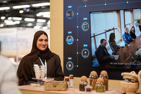 MBRSC representative at the hospitality counter beside the mission timeline