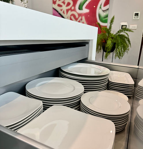 Open kitchen drawer with crockery