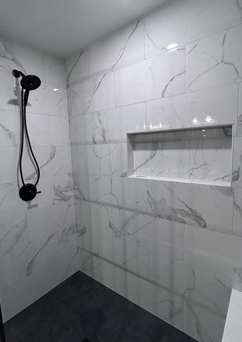 White marble with gray veining shower, large shampoo niche