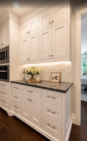 White custom beverage station with marble backsplash, stone countertop, integrated storage, and crown moulding.