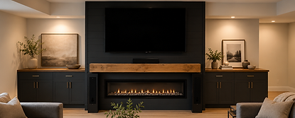 Modern basement living room with a black shiplap feature wall, linear gas fireplace, and oversized mounted television. The space features built-in black cabinetry with warm wood countertops, a rustic wood mantel, neutral furnishings, recessed lighting, and a large wood coffee table in a cozy contemporary setting.