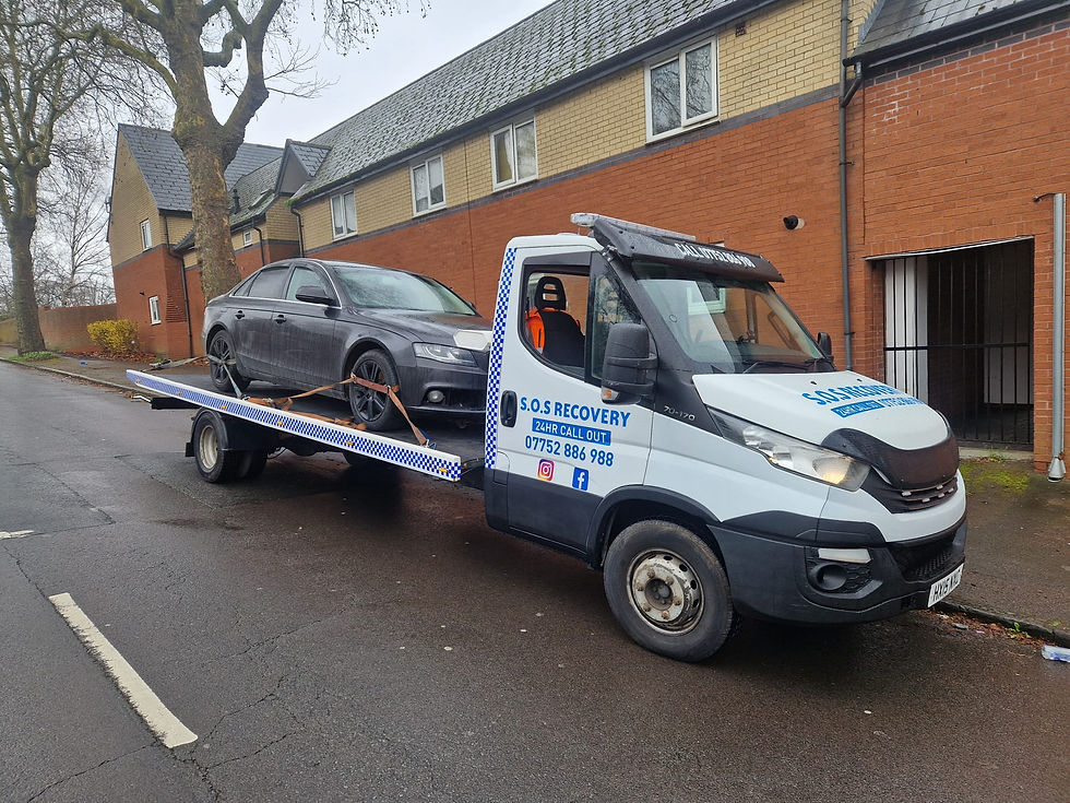 Accident recovery services UK truck towing a damaged car