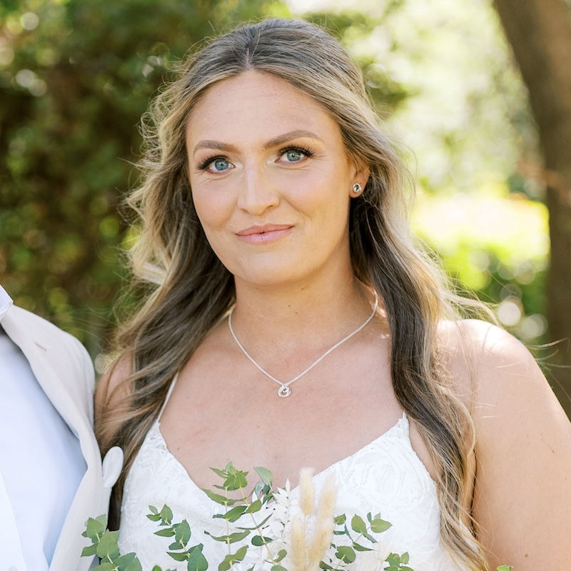 beautiful bride with professional hair and makeup by Jacqueline Parker Creative in perth, holding a bouquet and smiling