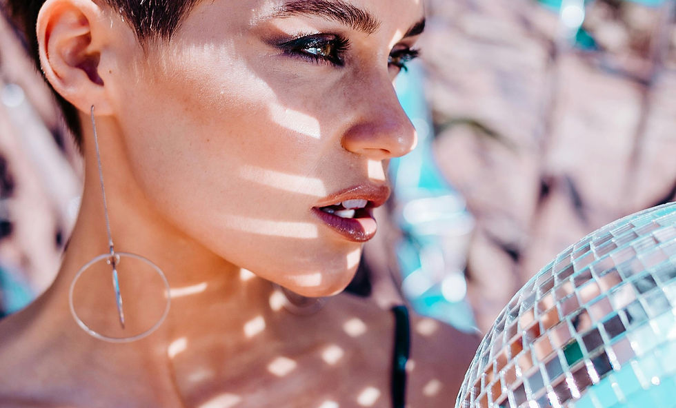 Woman with makeup and disco ball reflecting light