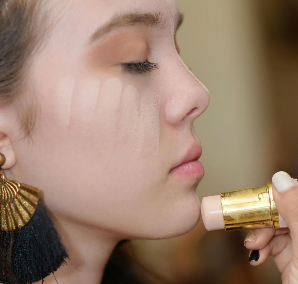 woman applying stick foundation