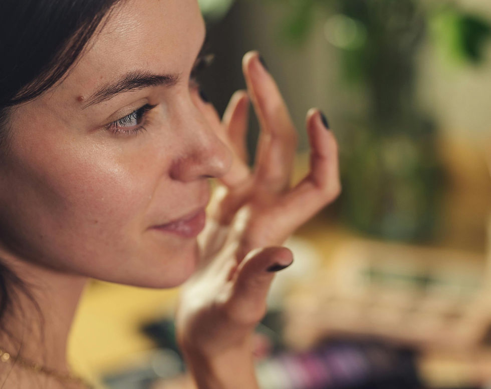 woman applying foundation makeup with fingers