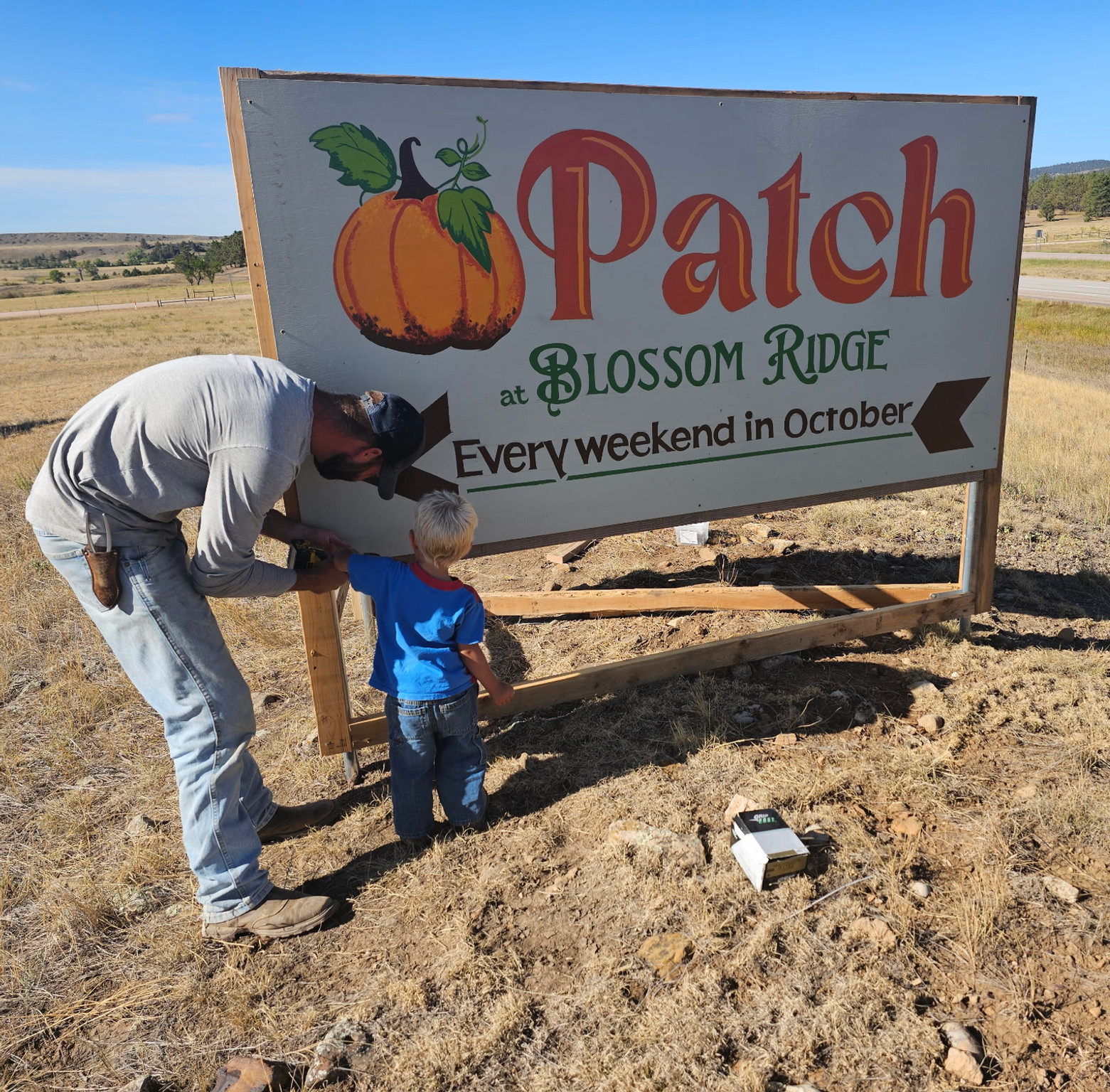 Boys installing our first sign.