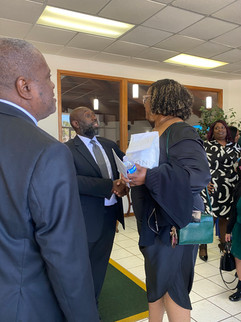 Pastor Thompson greeting member in lobby