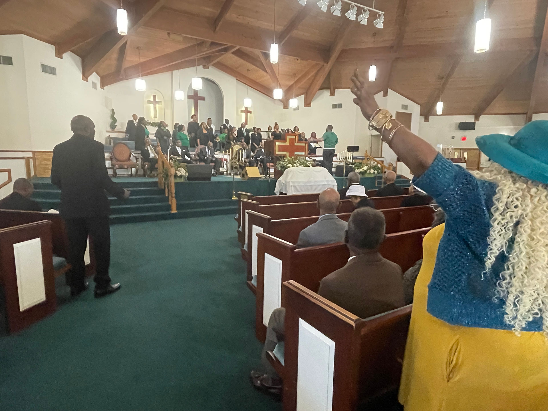 choir singing in sanctuary, woman with hands raised