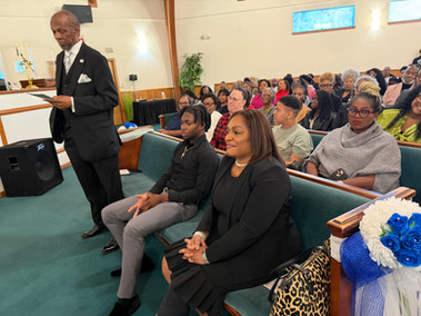 Pastor Thompson's family, wife and son sitting on first row