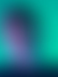 Man with neutral expression in a blue and green-lit setting. He wears a dark shirt, hair slightly long, and stands against a smooth gradient background.