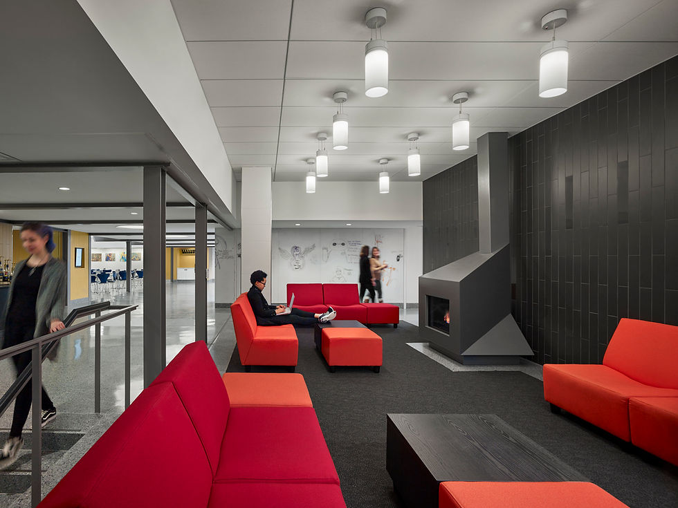 Interior of Moore College of Art & Design’s Student Commons by MGA Partners, featuring contemporary lounge furniture, a fireplace, and collaborative study areas.