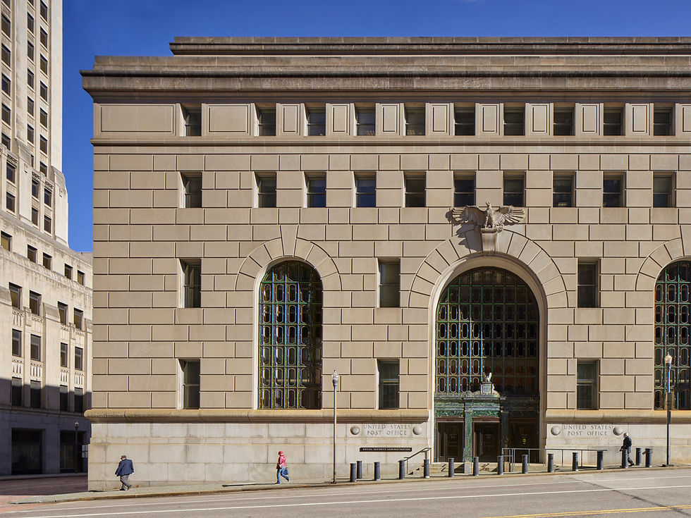Front façade of the historic Weis Courthouse in Pittsburgh designed by MGA Partners, featuring arched stone entryways and classical detailing.