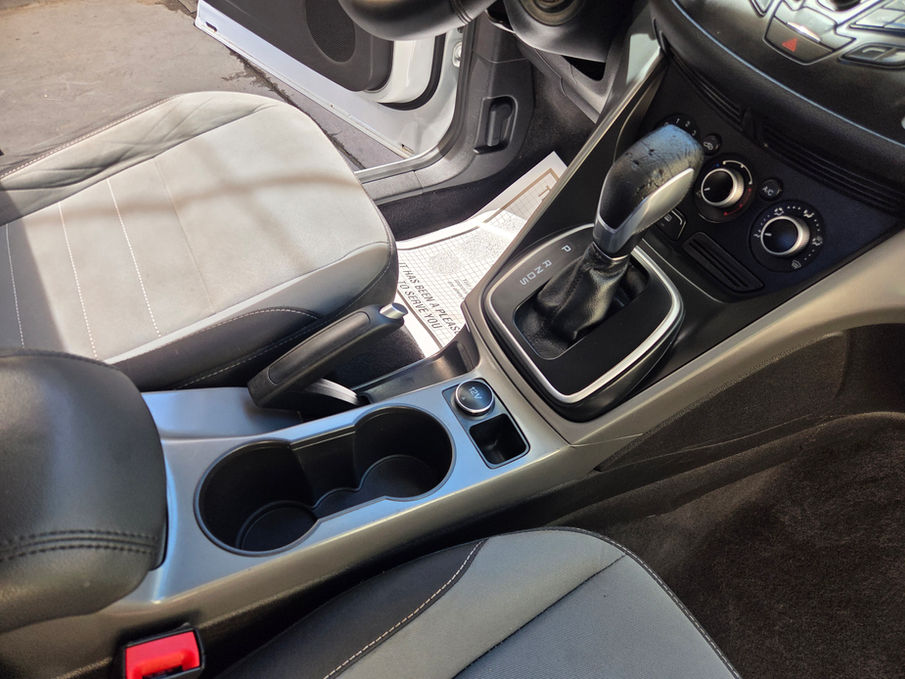 Modern car interior with gear shift and cup holders
