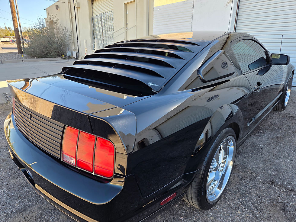Black Ford Mustang rear view with window louvers