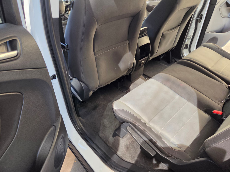 Clean grey fabric rear seats and floor mats in a car interior