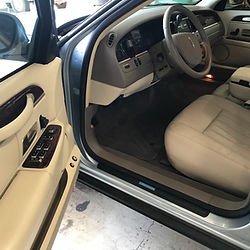 Clean luxury car interior with beige leather seats.