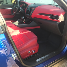 Clean red leather interior of a multi-stage paint car