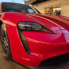 Red Porsche Taycan after multi-stage paint correction.