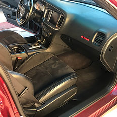 Clean interior of a red car after multi-stage detailing.