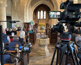 View of a church service from the rear with live stream camera in foreground