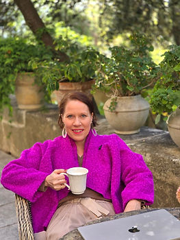 A woman having coffee outdoors
