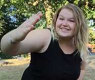Woman faces the camera signing. Caption says Sweden